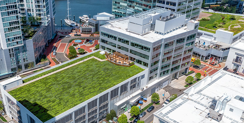 100-washington-card Aerial view of the rooftop of 100 Washington Boulevard in Stamford, CT, with patio and outdoor space and a view of Stamford Harbor.