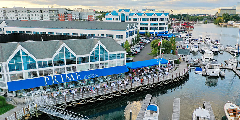 78 Southfield Office Space View of buildings and marina at 78 Southfield from Stamford Harbor, including outdoor diners at Prime restaurant