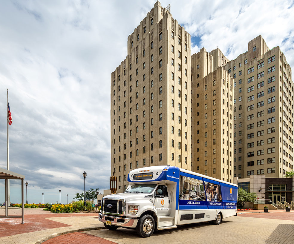 Shuttle bus in front of an apartment building at Beacon Jersey City